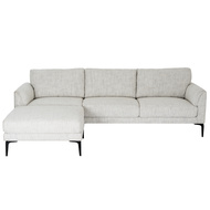 Modern neutral textured 3-seater sofa with matching footstool chaise in a bright living room